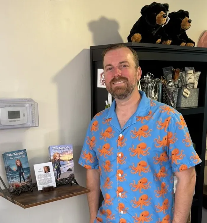 Luke Kilpatrick at the Ocean View BNB with Mia Kingtide books