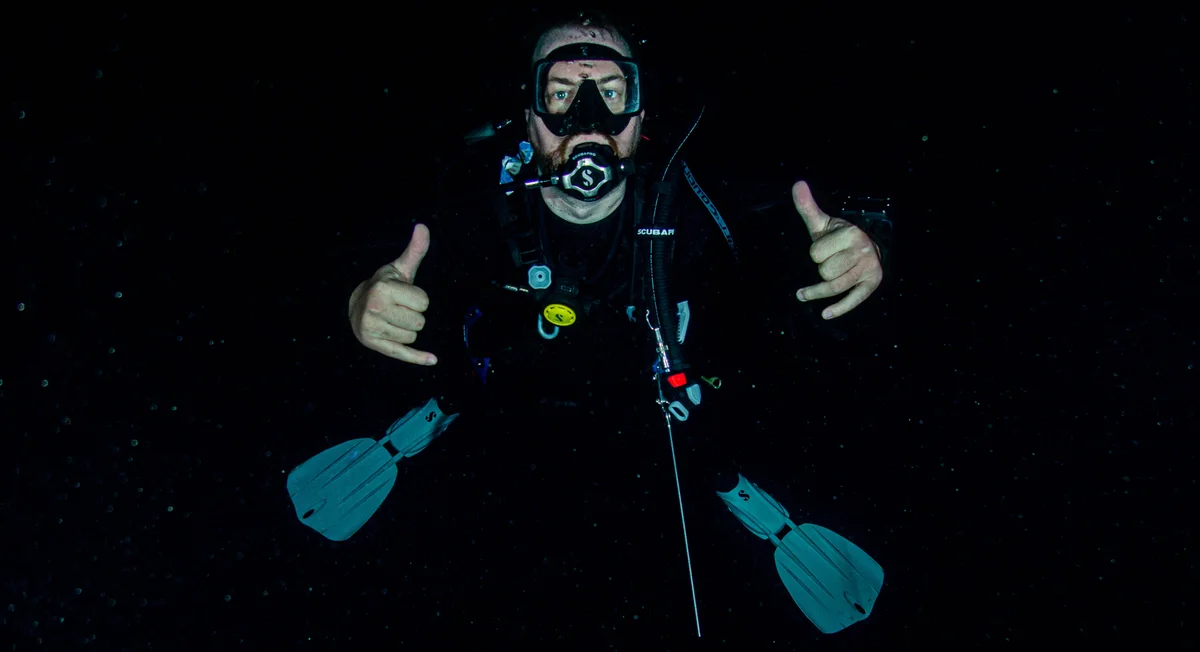 Luke Kilpatrick giving thumbs up at 200 feet underwater
