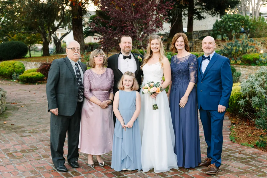 The Kilpatrick family gathered at the wedding. Both sets of parents, Luke, Jessica, and Mia